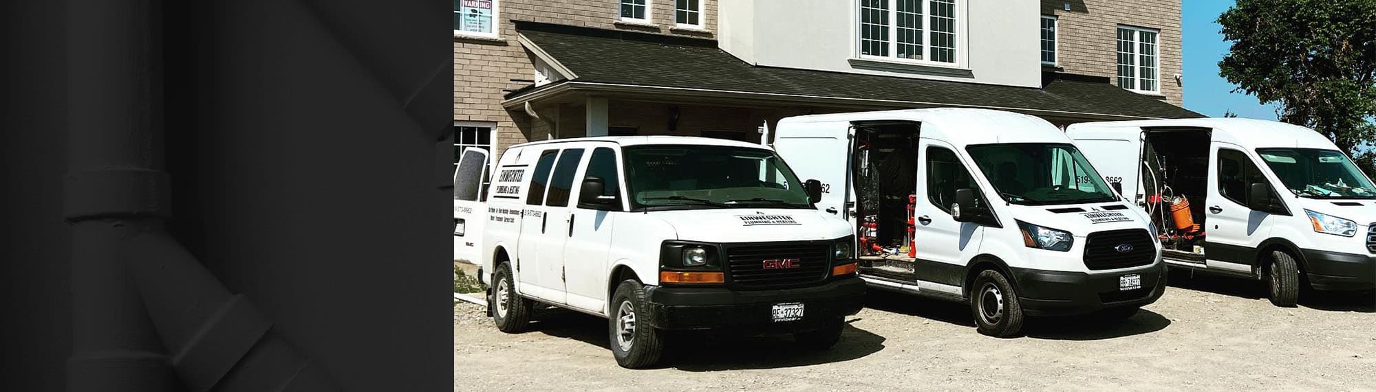 Row of Einwechter Plumbing & Heating service vans staged outside a residential property